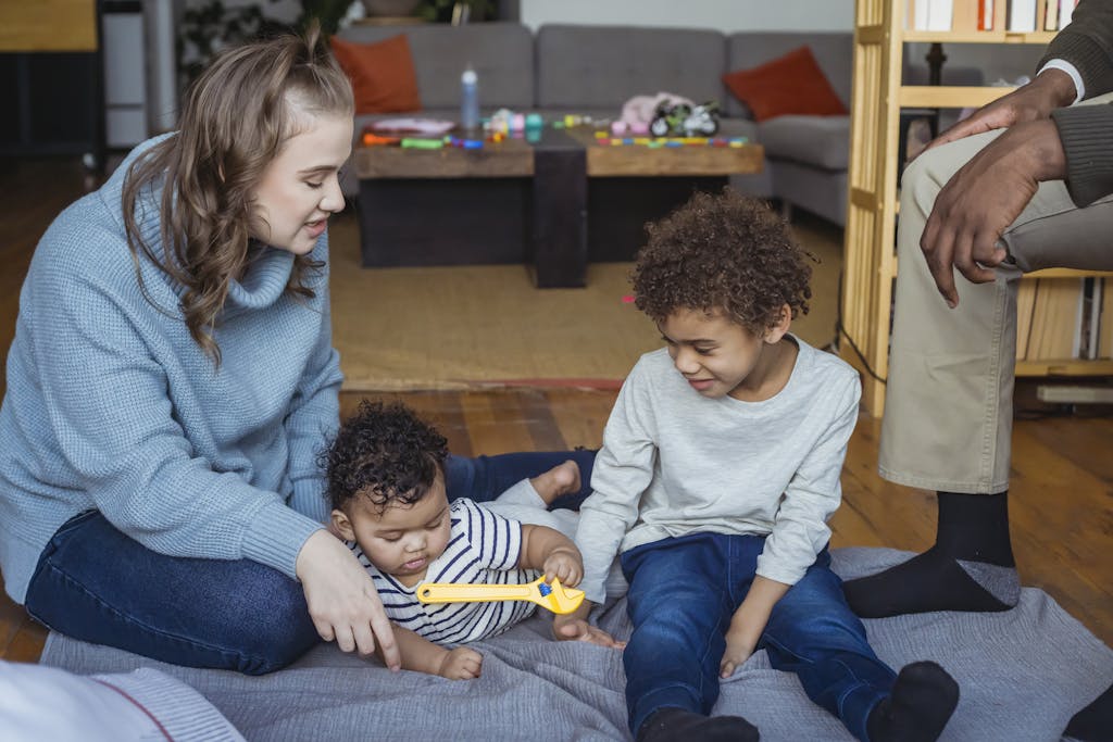 Mother and black son playing with baby
